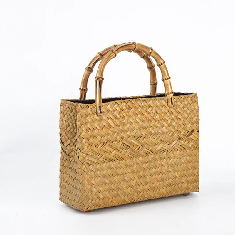 Woven handbag with bamboo handle on a white background