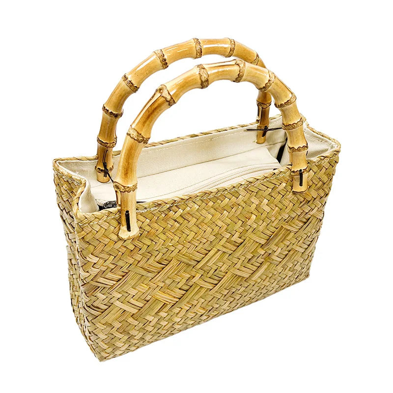 Woven handbag with bamboo handles on a white background