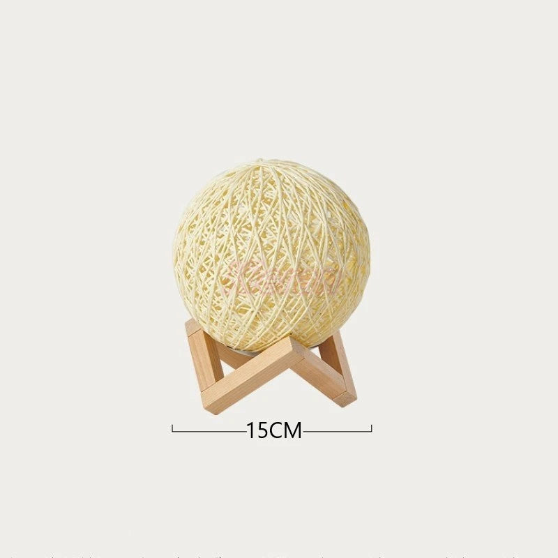 Woven ball light on a stand with a measurement label on a white background