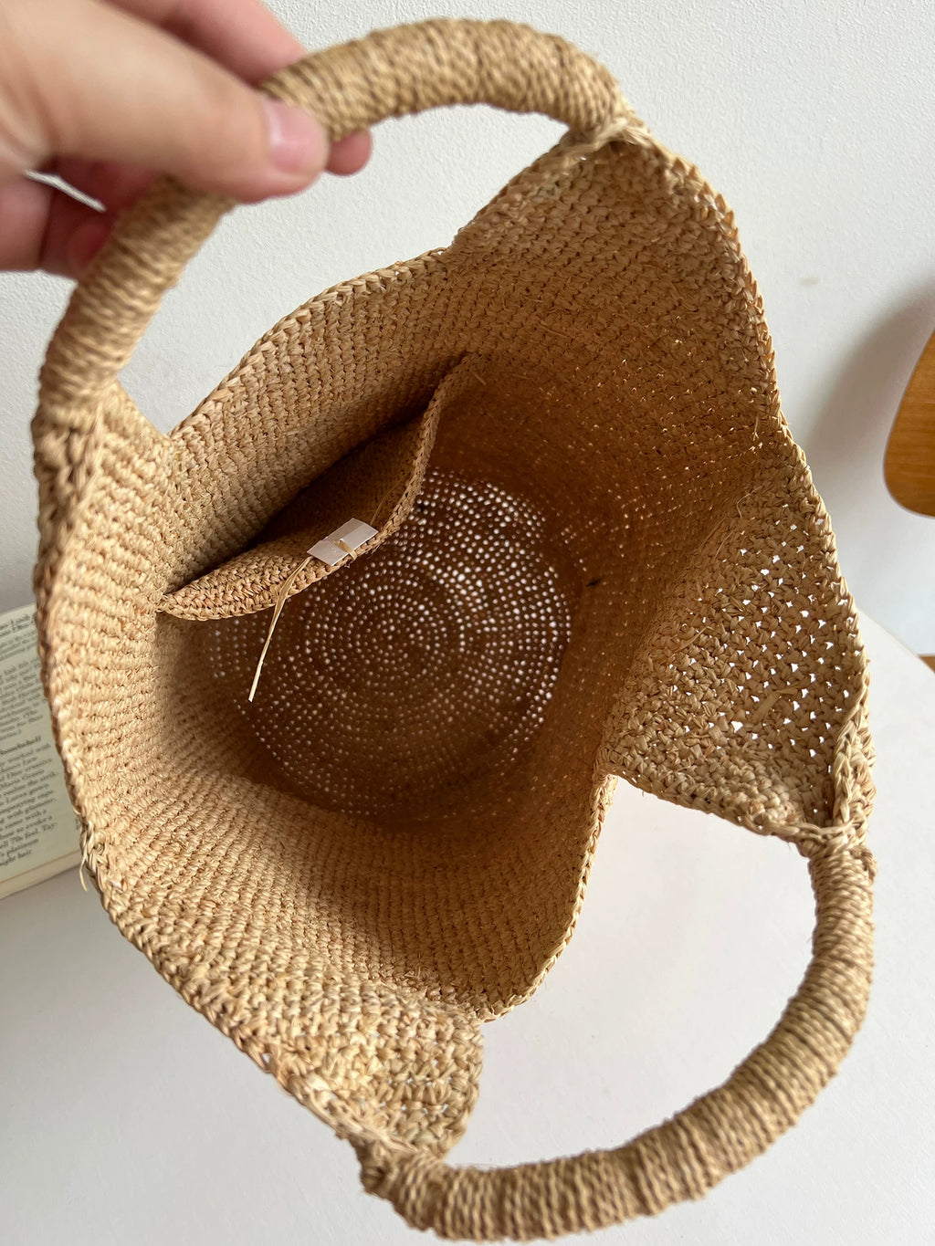 Woven basket with a decorative item inside on a white background
