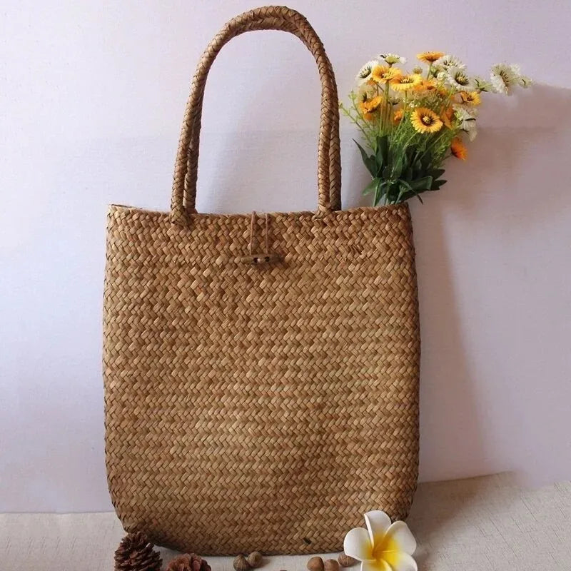 Woven straw bag with flowers on a light background