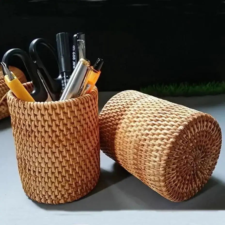 Woven brown pen holder with stationery items on a dark background