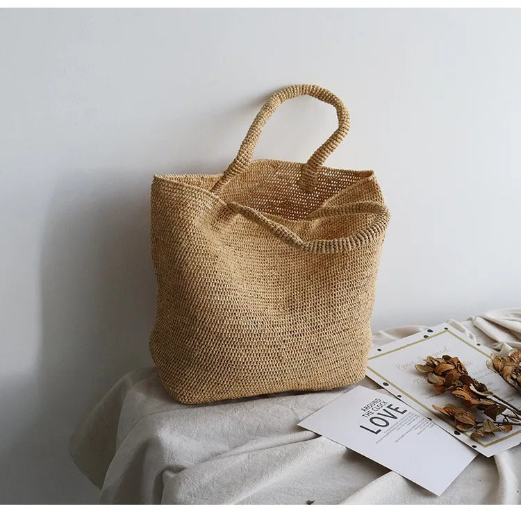 Woven straw bag on a light surface with a minimal background