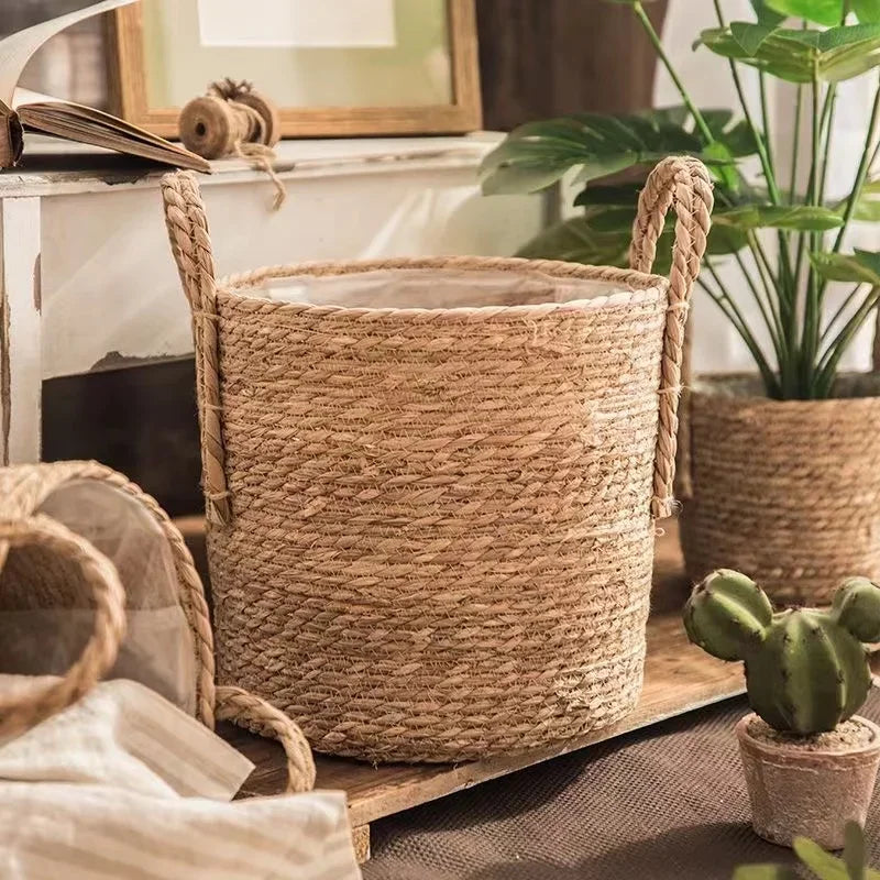 Woven basket on a surface with plants and books in the background