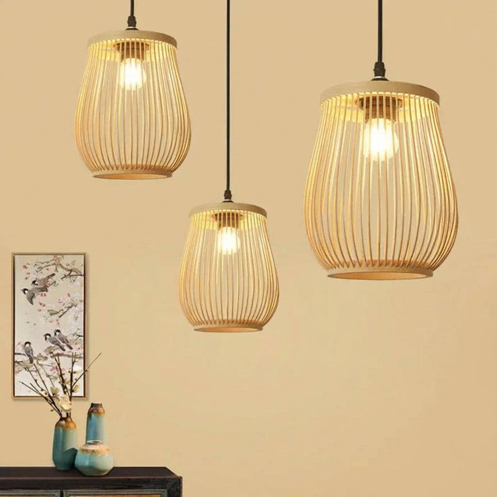 Three bamboo wooden pendant lights hanging against a beige wall with decorative elements.