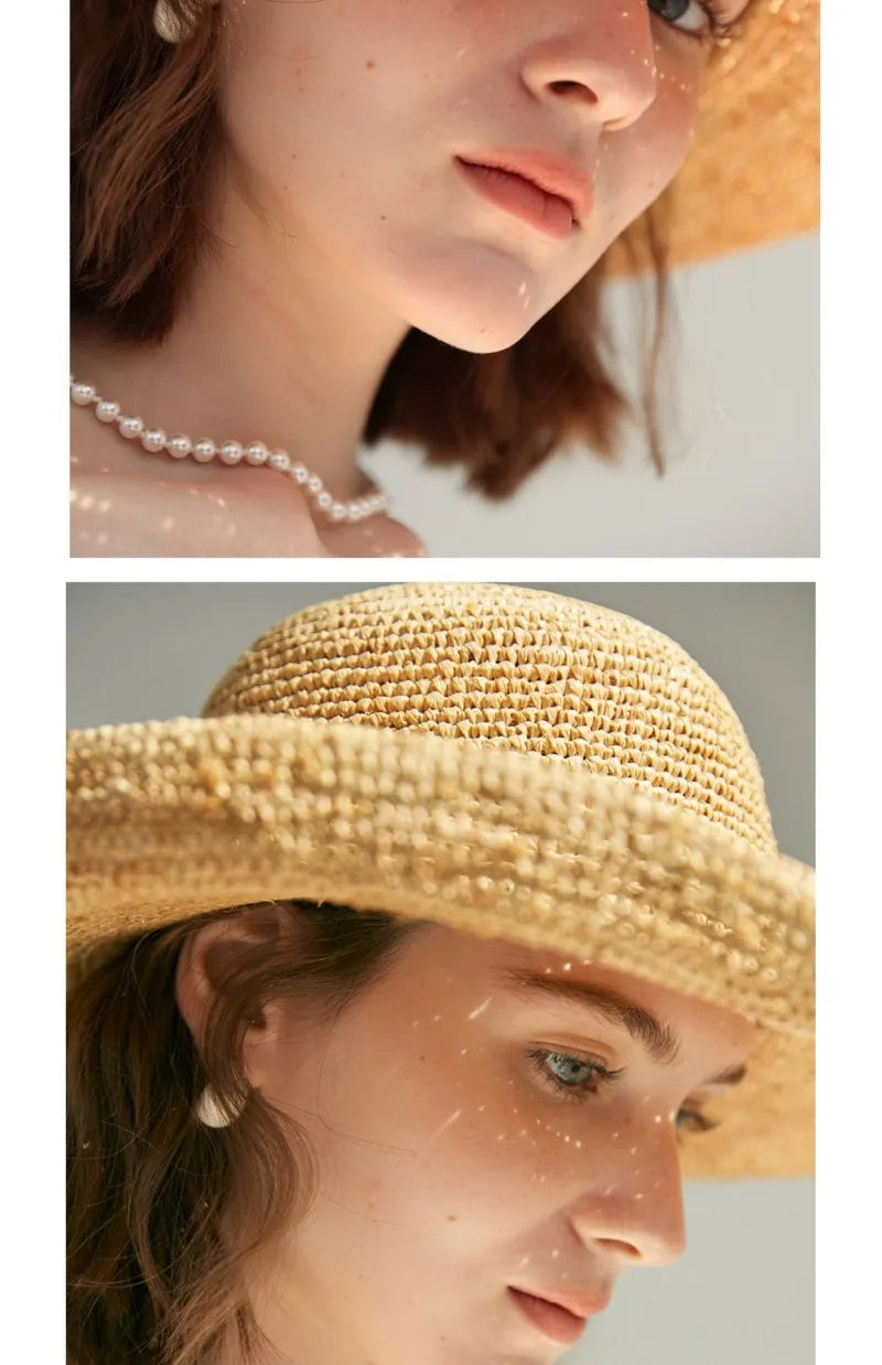 Close-up of a person wearing a straw hat and pearl necklace with a blurred background.