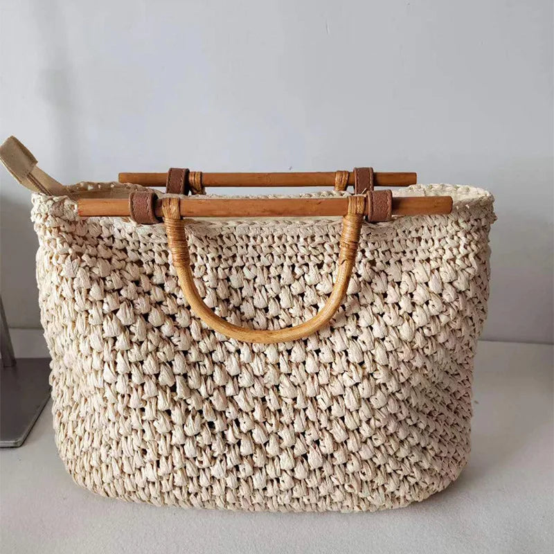 Woven handbag with wooden handles on a light surface