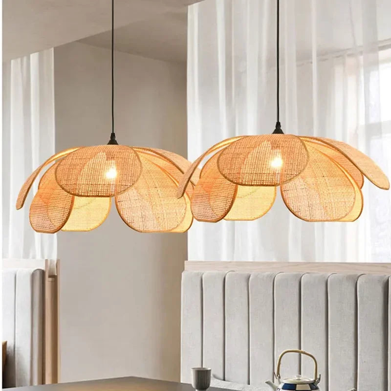 Floral-shaped pendant lights hanging in a room with a neutral color scheme, made of woven rattan