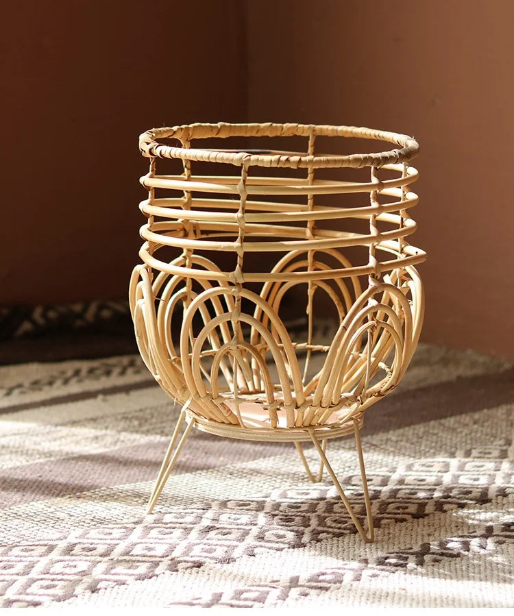 Woven rattan basket with decorative legs on a textured surface, branded 'YUANJIE HOME'.