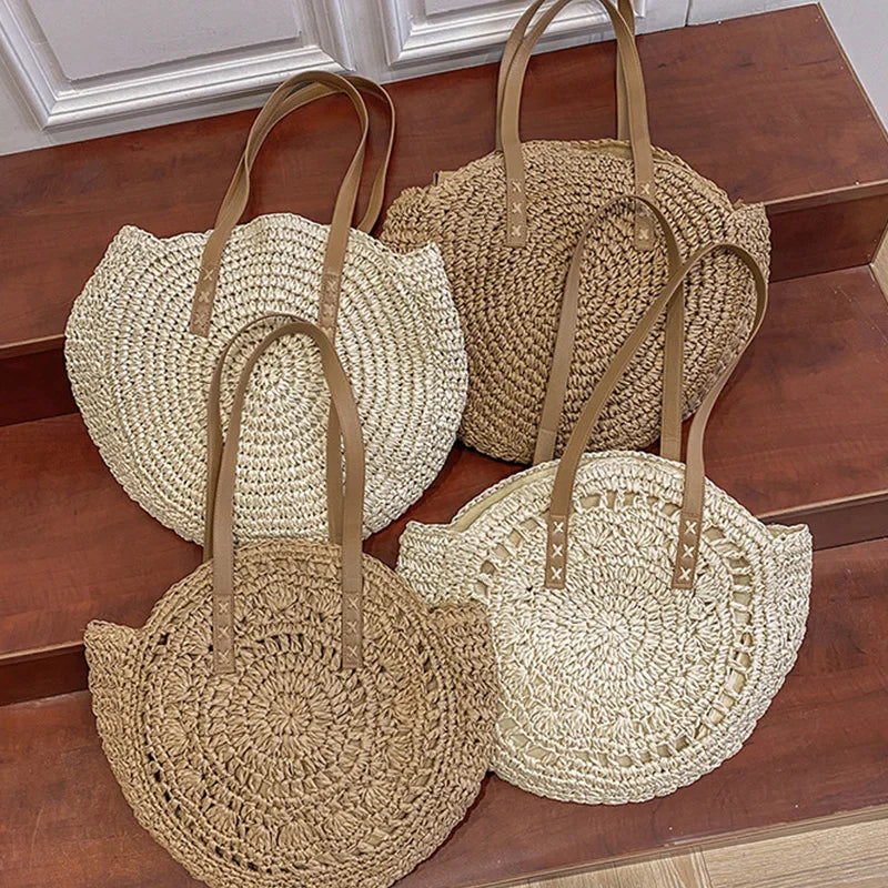 Four woven bags in beige and brown on a wooden surface.