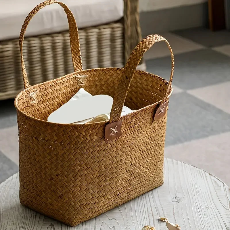 Woven basket with handles on a wooden surface