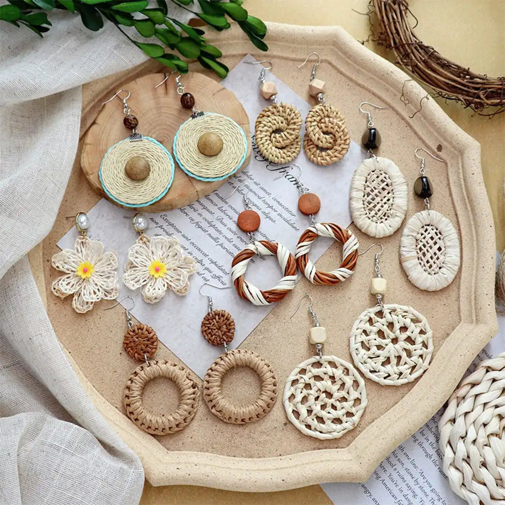 Assorted earrings on a decorative tray with a natural background