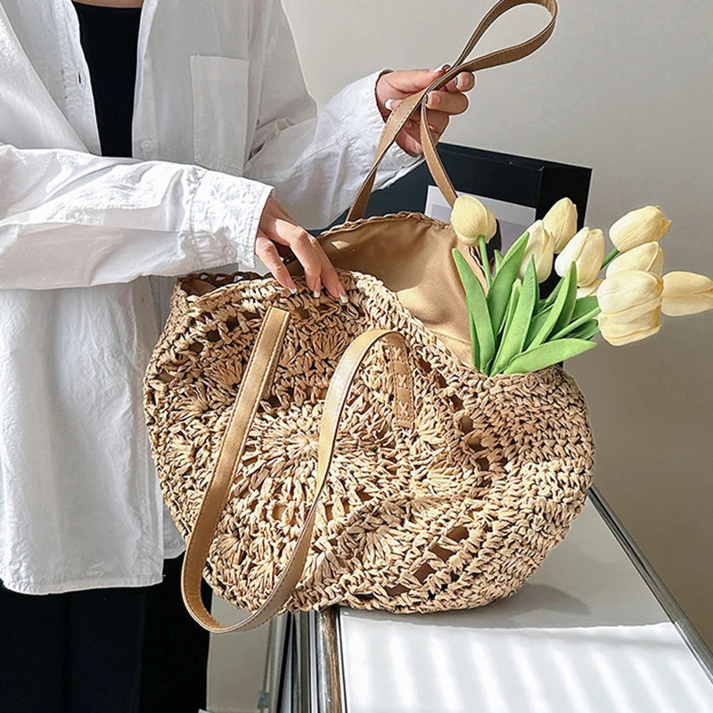 Person holding a woven bag with flowers against a neutral background