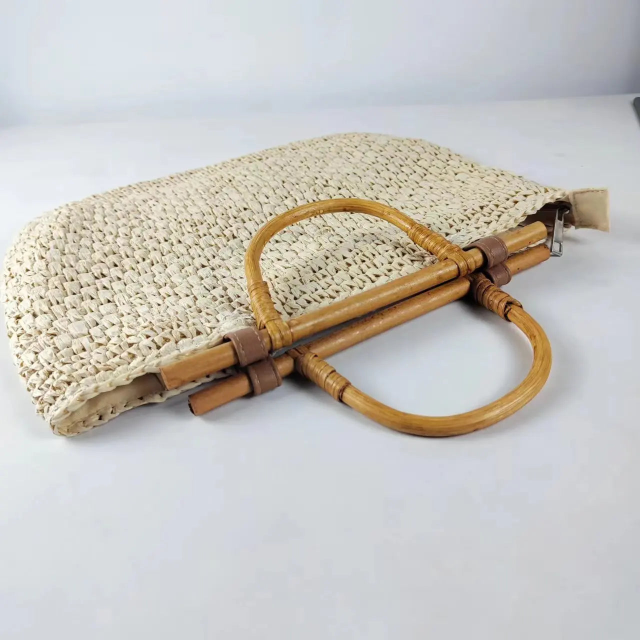 Woven handbag with wooden handles on a white background