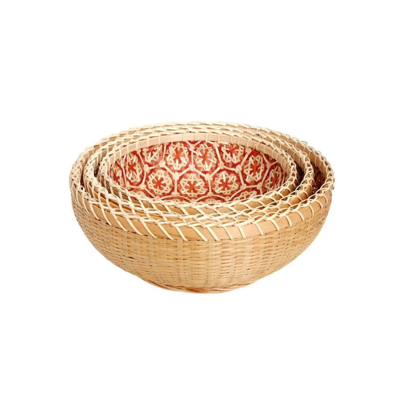 Set of three woven baskets with a red floral pattern on a white background