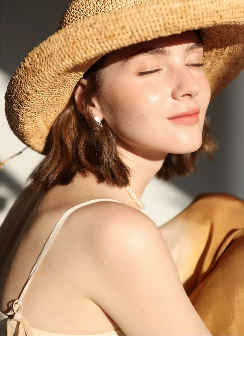 Woman wearing a straw hat with a blurred background