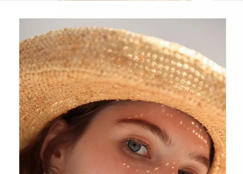 Close-up of a person wearing a straw hat with a neutral background