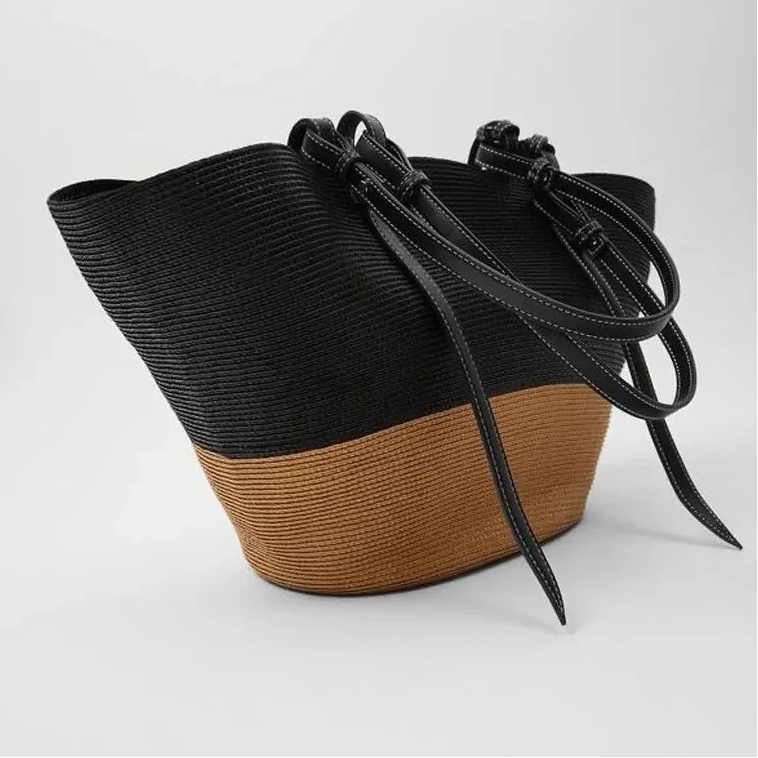 Black and brown woven bucket bag on a white background