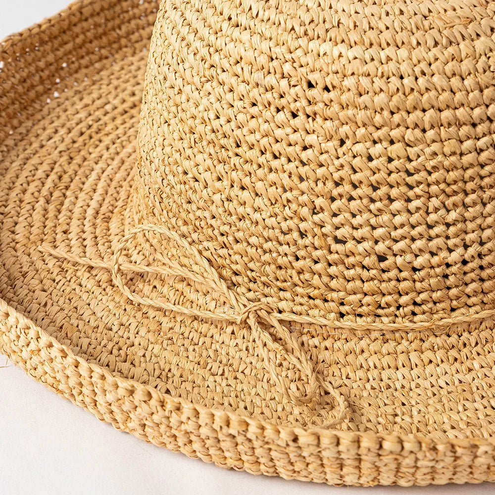 Close-up of a woven straw hat on a light background