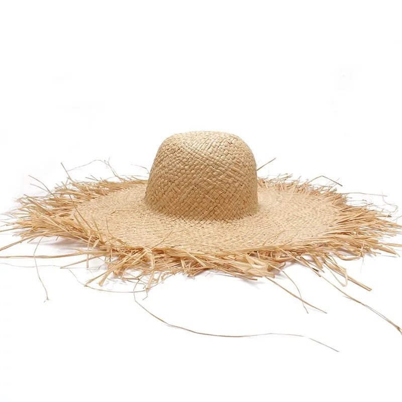 Beige straw hat with frayed edges on a white background