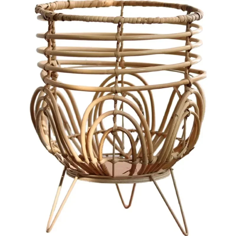 Wicker basket with metal legs on a white background
