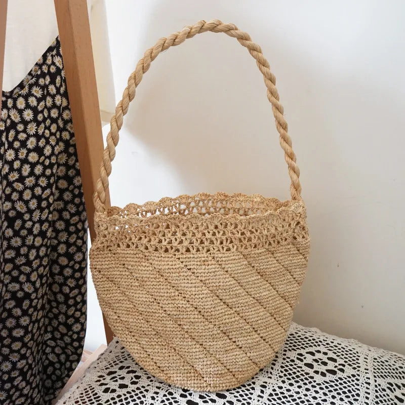 Woven basket with a rope handle on a surface with a patterned fabric background