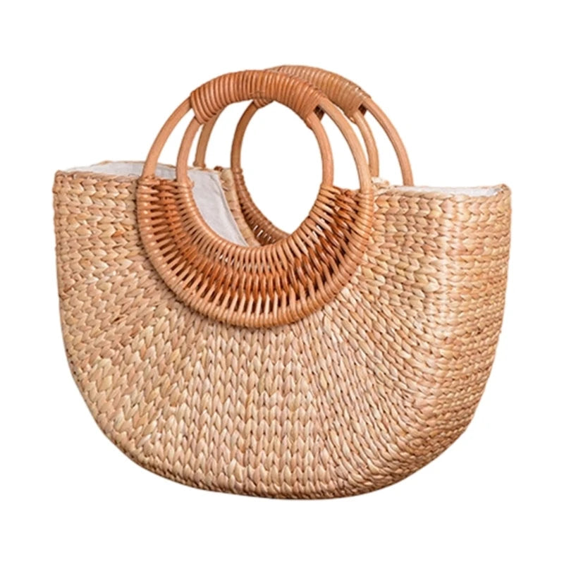 A natural woven straw tote bag with integrated circular handles, shown against a plain white background.