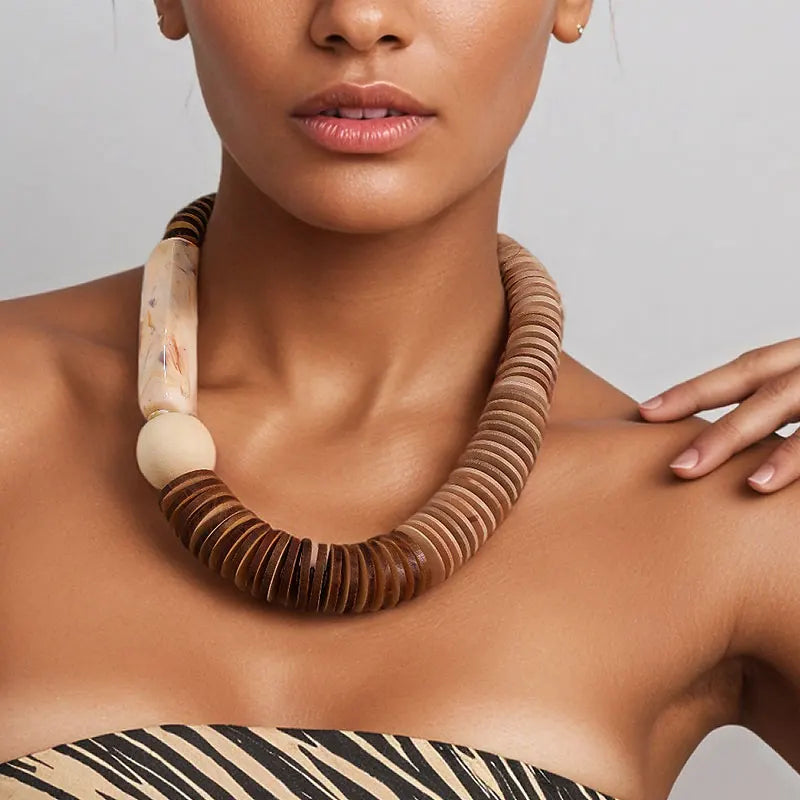 Close-up of a woman wearing a wooden necklace with a neutral background