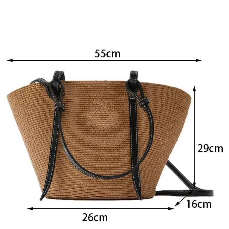 A tan woven straw tote bag with black handles and a black shoulder strap, shown with dimension lines and measurements: 55 cm width, 29 cm height, 26 cm base width, and 16 cm strap depth. 