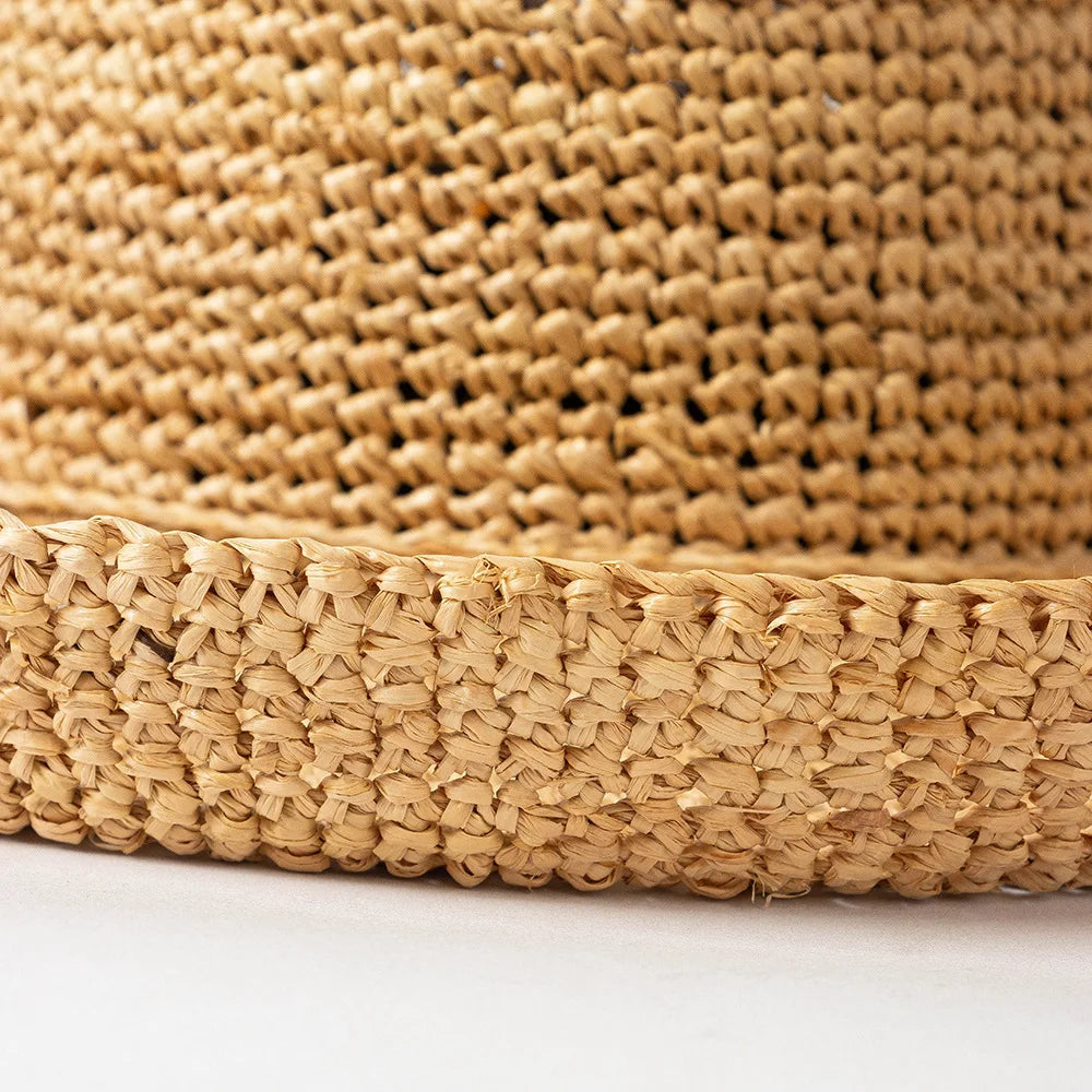 Close-up of a woven straw basket on a white background