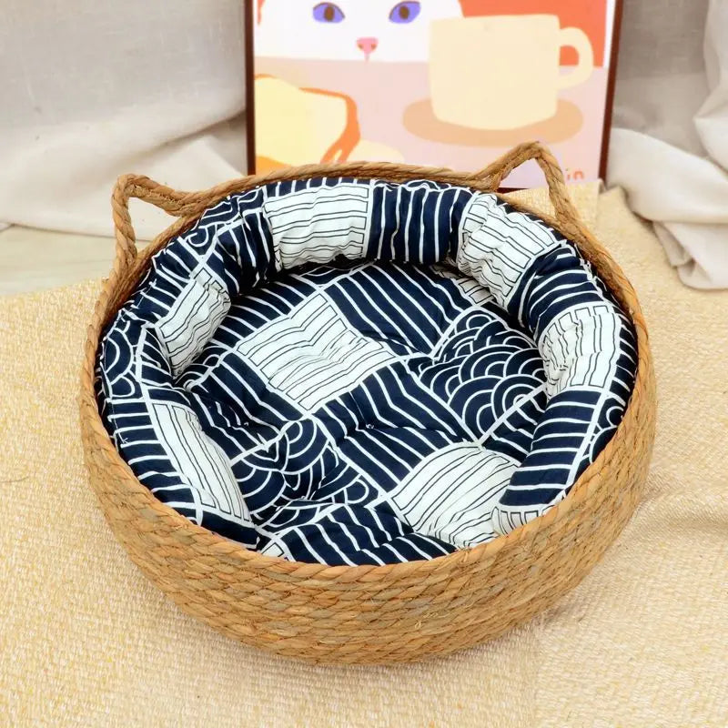 Woven pet bed with a blue and white patterned cushion on a beige surface.