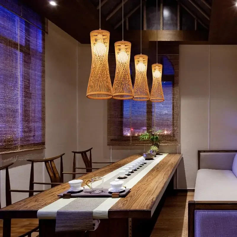 Modern dining room with wooden table, chairs, and pendant lights.