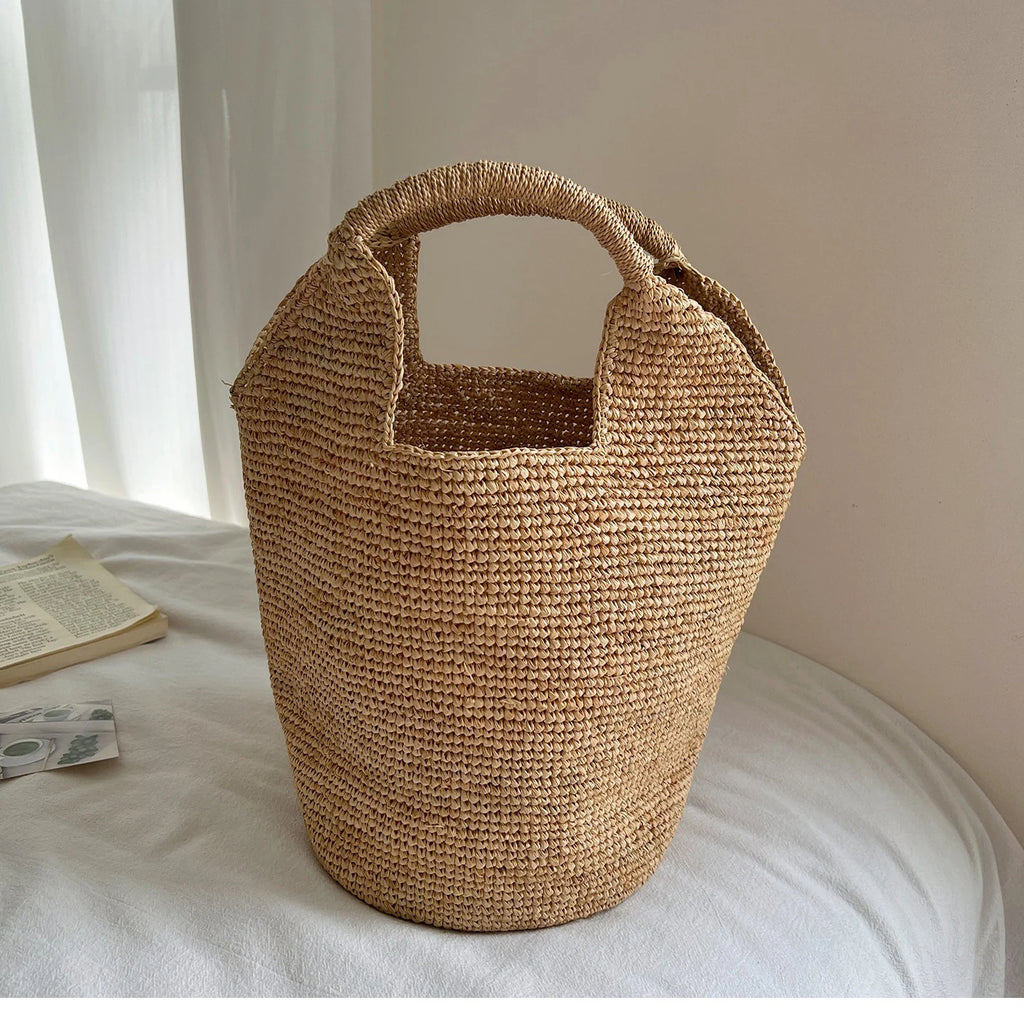 Woven basket on a bed with a book and money on a white background