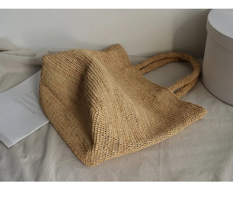 Woven beige handbag on a light surface with a white background