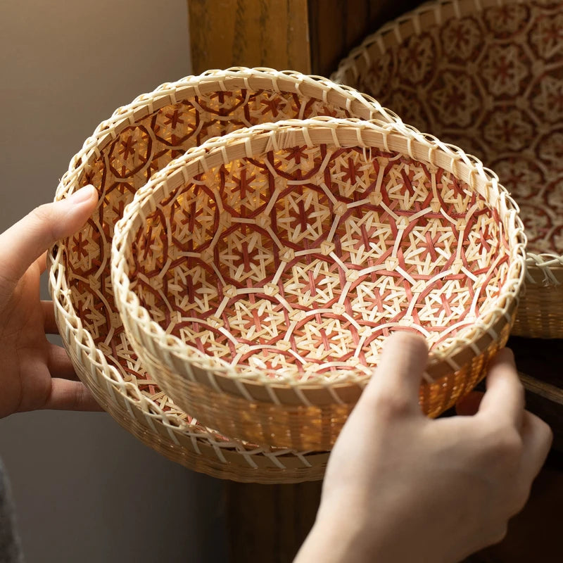 Woven basket with geometric pattern held by a person's hands