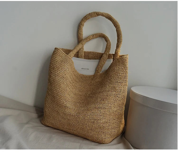 Woven brown bag on a light surface with a neutral background