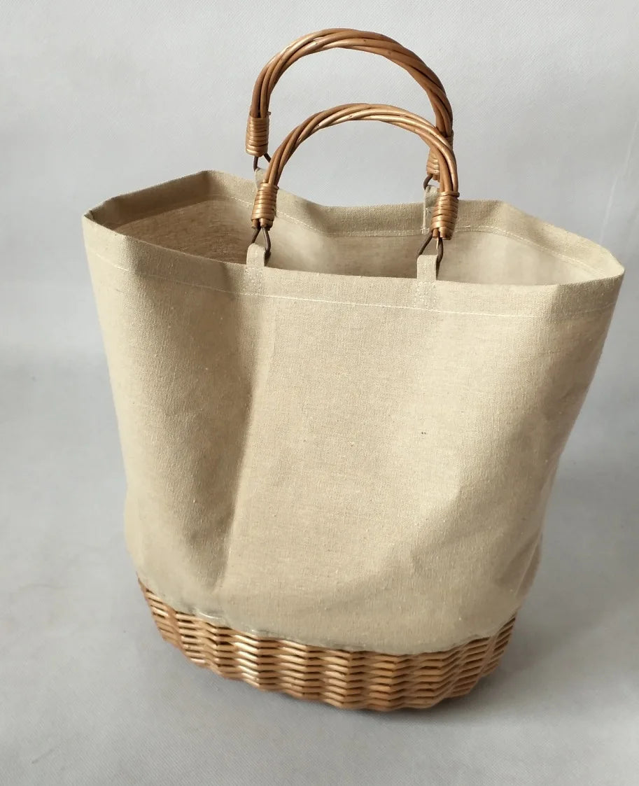 Beige tote bag with wicker handle and base on a light gray background
