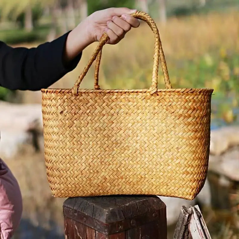 Woven basket held by a person with a blurred natural background