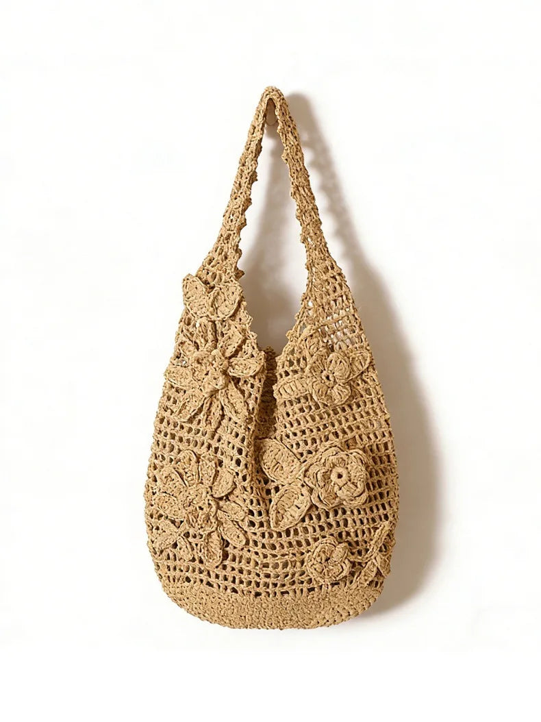 Beige crochet handbag with floral patterns on a white background