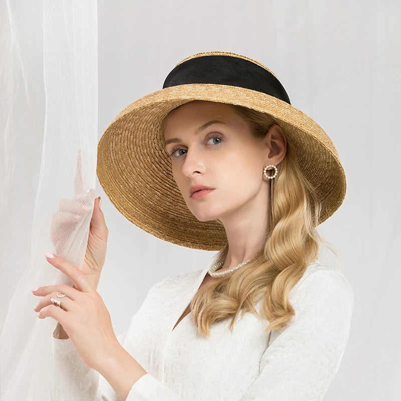 Woman wearing a straw hat with a black band on a white background