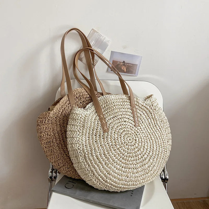 Two woven handbags with leather straps on a white surface.