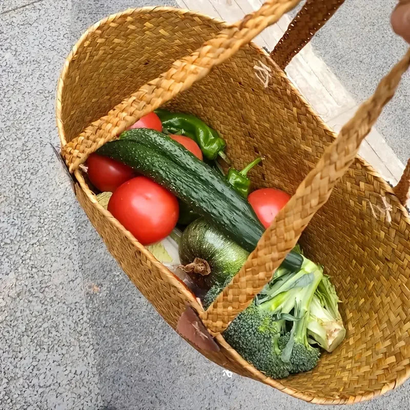 Wicker basket filled with fresh vegetables on a concrete surface
