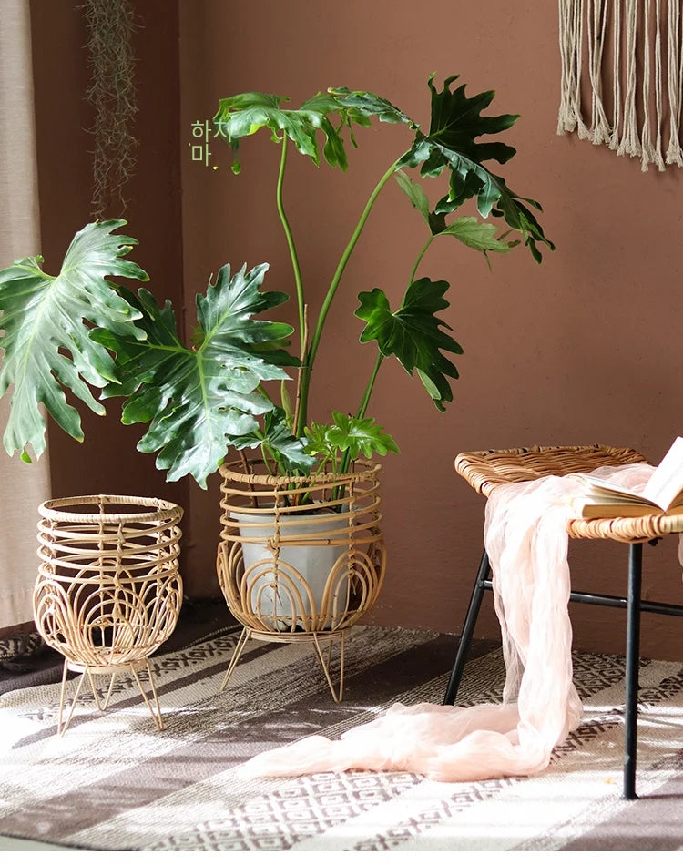 Decorative indoor setting with plants, wicker baskets, and a chair against a brown wall.