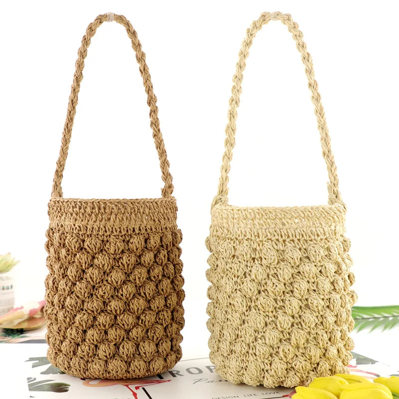 Two woven handbags, one brown and one beige, on a white background. bucket straw bags