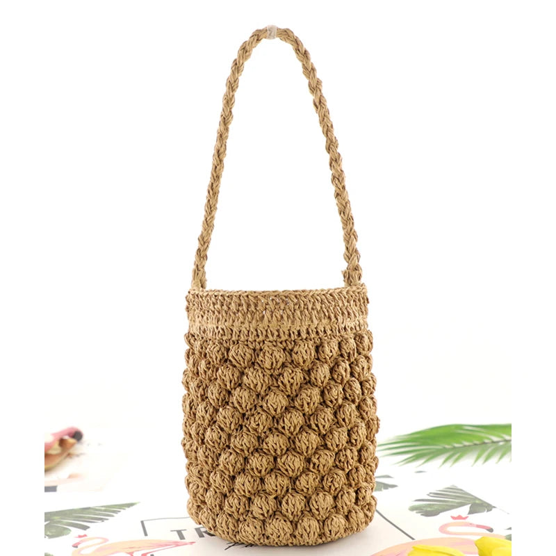 Brown woven handbag with a handle on a white background